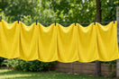 Lemon-yellow microfiber towels on a clothesline