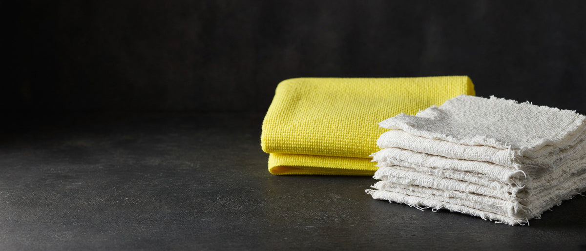 Yellow warp-knit towel and white sheeting rags