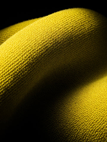 Explore Towels banner — yellow warp-knit packs