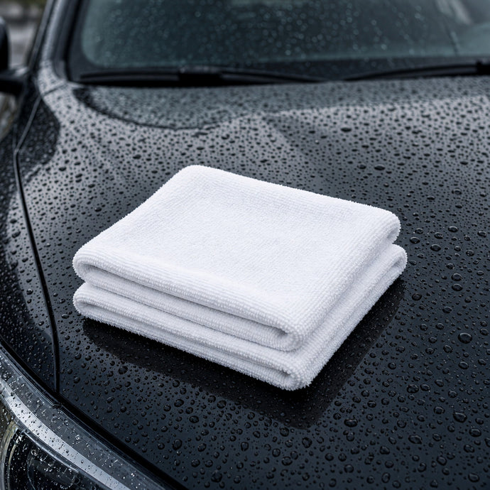 Gray twisted-loop drying towel on a wet car hood